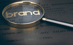 brand under a magnifying glass on table