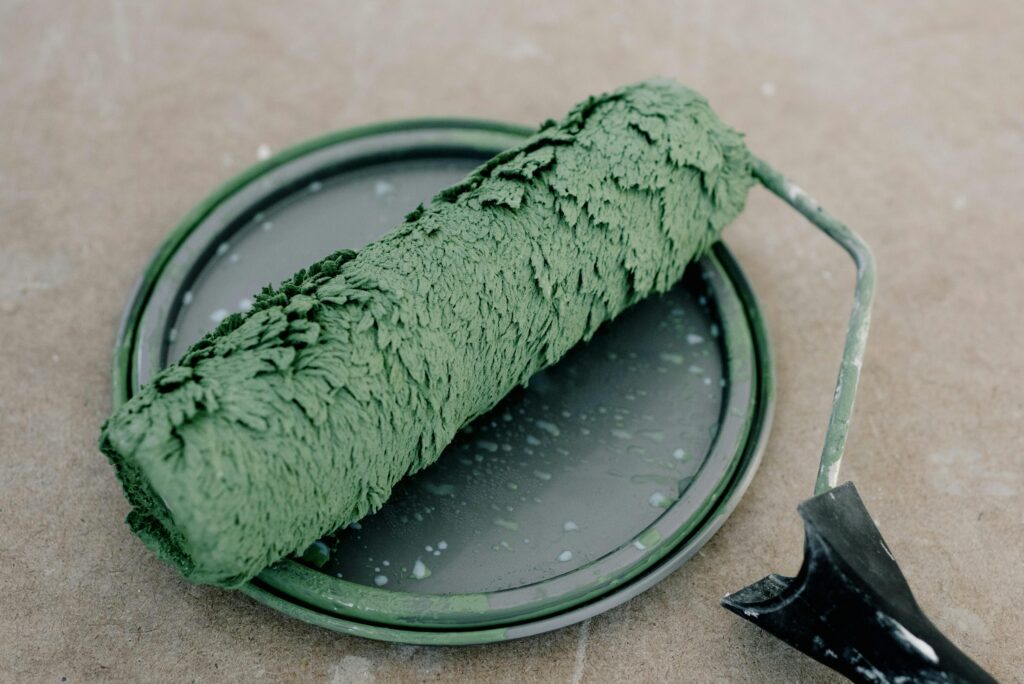 green paint with brush on jug